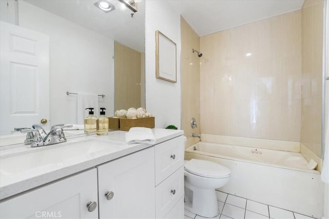 full bathroom featuring tiled shower / bath, vanity, toilet, and tile patterned floors