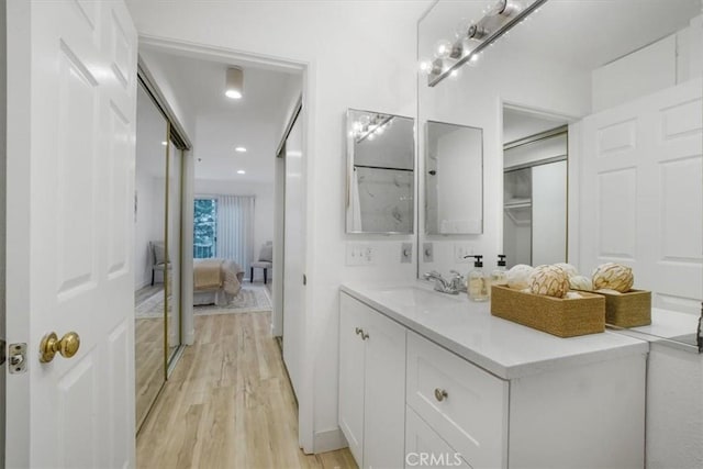 bathroom featuring hardwood / wood-style flooring and vanity