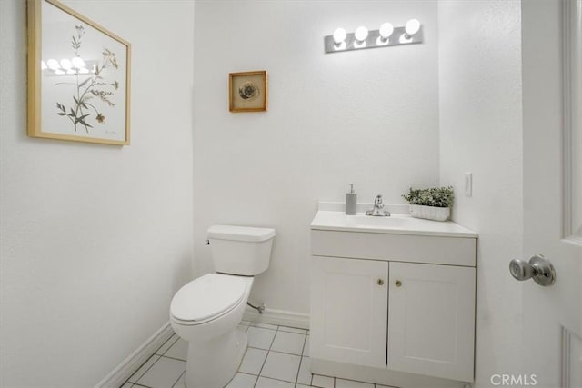 bathroom featuring tile patterned floors, vanity, and toilet