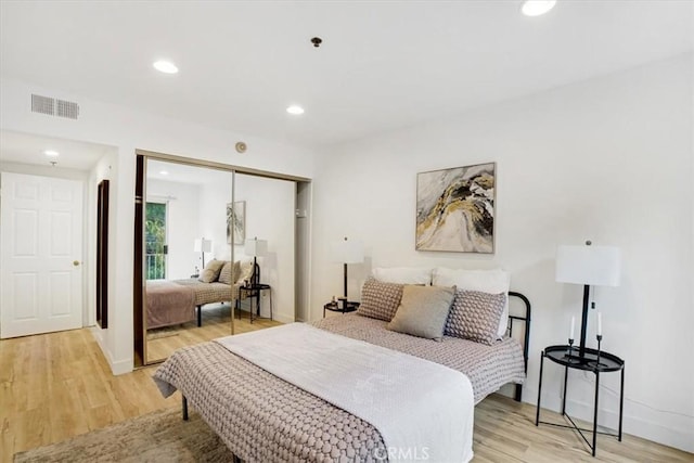 bedroom featuring light hardwood / wood-style floors and a closet