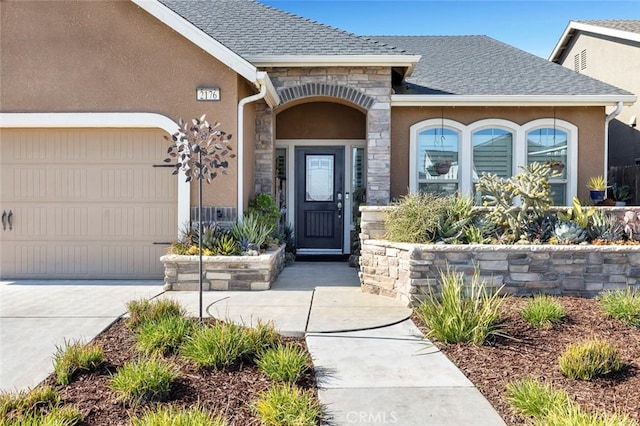 view of exterior entry with a garage