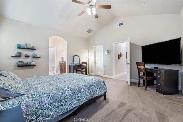 carpeted bedroom with ceiling fan, ensuite bathroom, and vaulted ceiling