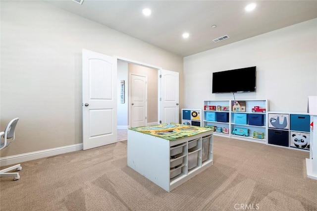 recreation room featuring light carpet