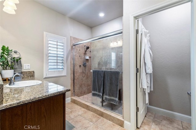 bathroom with tile patterned floors, vanity, and an enclosed shower