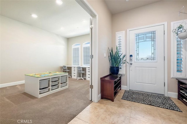 view of carpeted foyer entrance