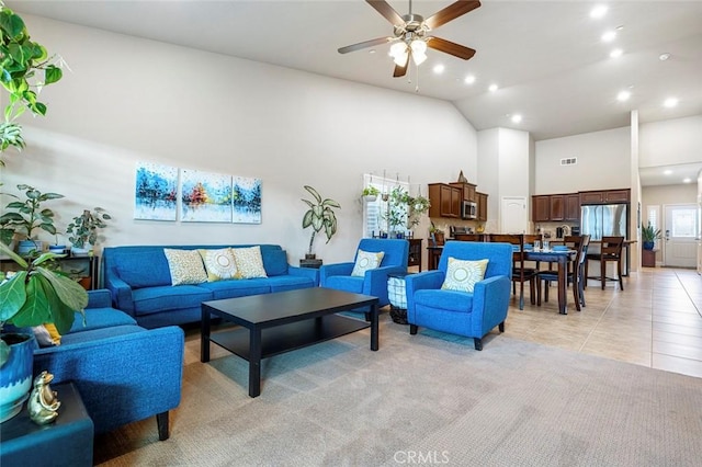 living room with light tile patterned floors, high vaulted ceiling, and ceiling fan