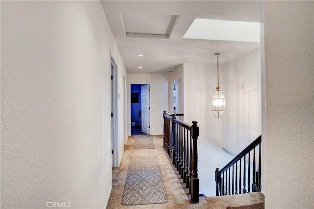 hallway featuring light colored carpet