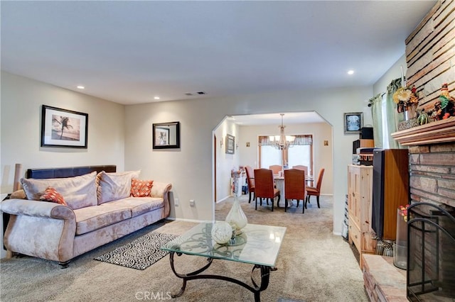 carpeted living room with a notable chandelier