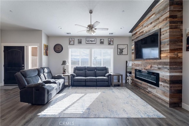 living room featuring a fireplace, dark hardwood / wood-style floors, and ceiling fan