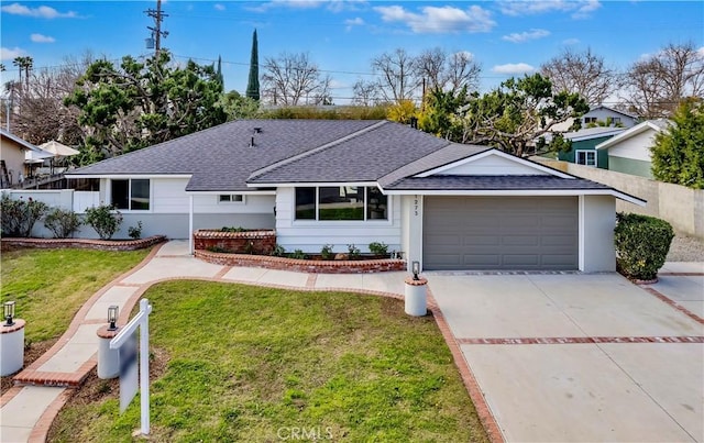 ranch-style house with a garage and a front lawn