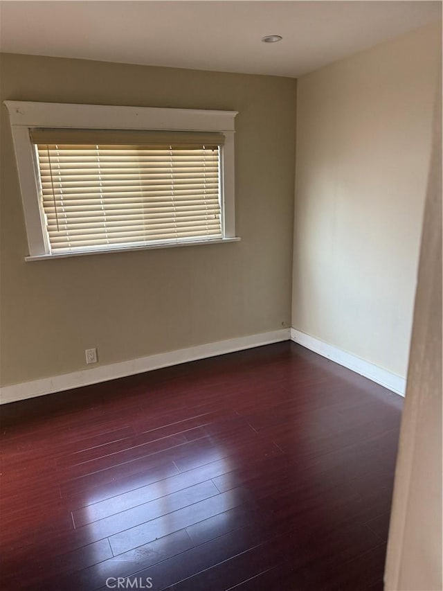 empty room with dark wood-type flooring