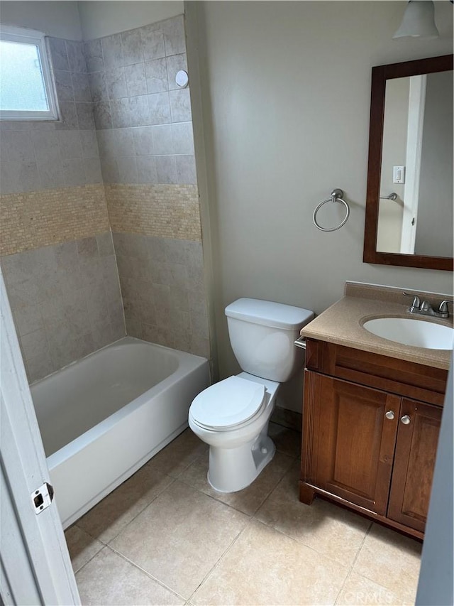 full bathroom featuring vanity, tiled shower / bath, tile patterned floors, and toilet