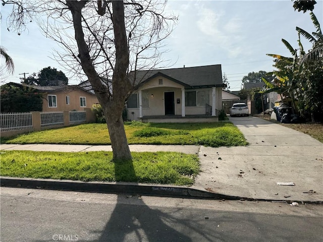 bungalow-style home with a front yard