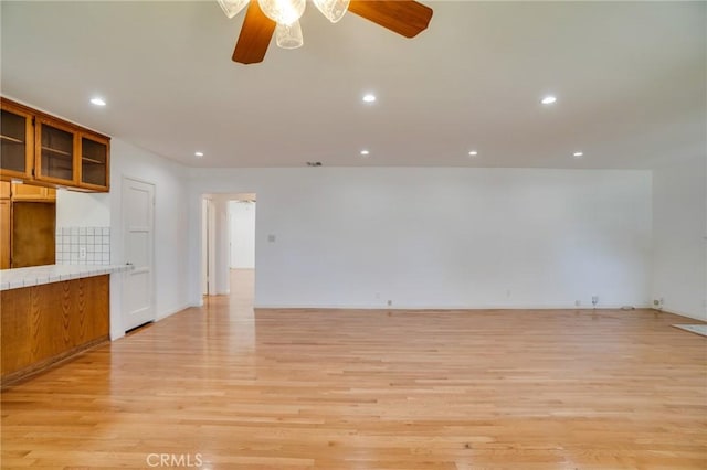 interior space featuring light hardwood / wood-style floors and ceiling fan