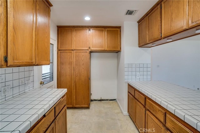 kitchen featuring tasteful backsplash and tile counters