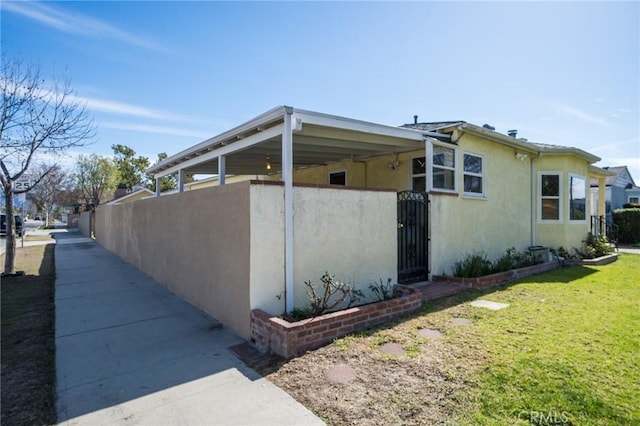 view of side of home with a lawn