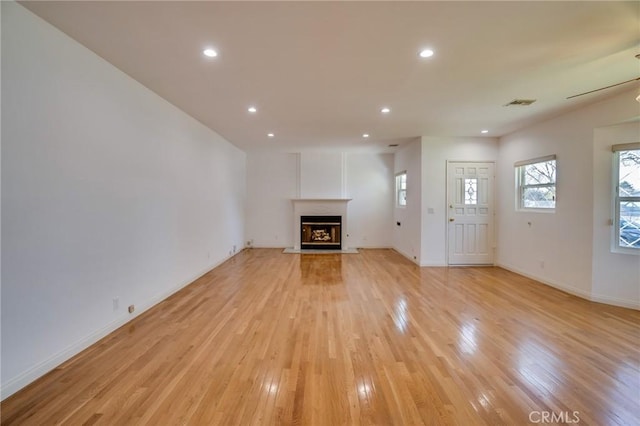 unfurnished living room featuring light hardwood / wood-style floors and ceiling fan