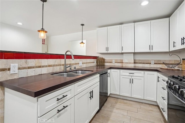 kitchen featuring pendant lighting, black dishwasher, sink, and white cabinets