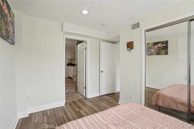 unfurnished bedroom with wood-type flooring and a closet