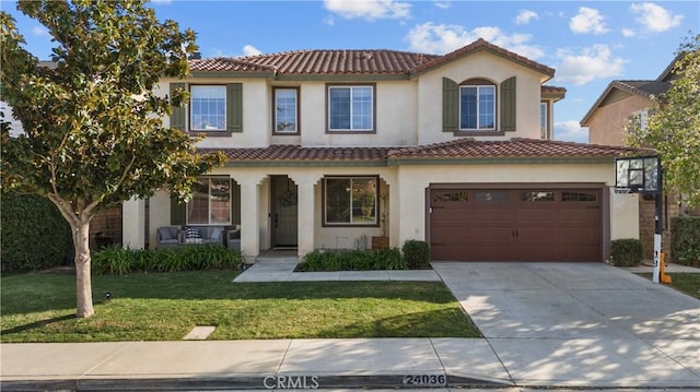 mediterranean / spanish-style house with covered porch, driveway, a front lawn, and a tile roof