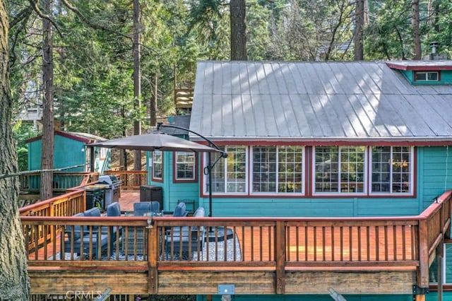 rear view of property with a wooden deck