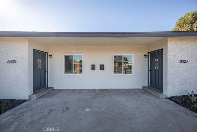 property entrance featuring a patio