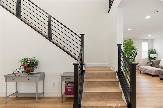 stairway with hardwood / wood-style floors