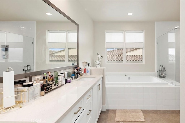 bathroom with vanity, plus walk in shower, and tile patterned flooring