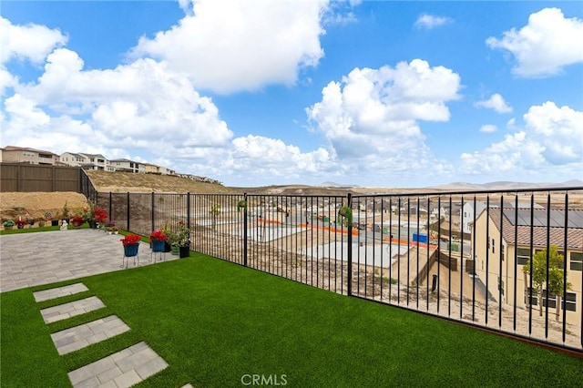 view of yard with a patio and a mountain view