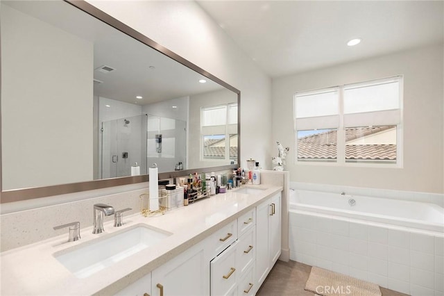 bathroom with vanity and separate shower and tub