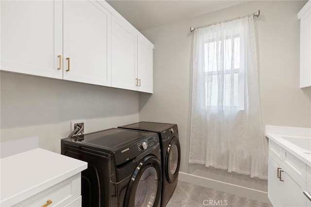 laundry area featuring cabinets and separate washer and dryer