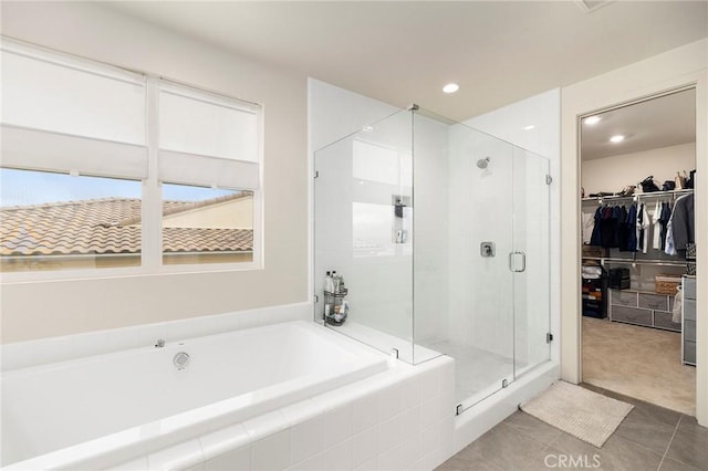 bathroom with tile patterned floors and shower with separate bathtub