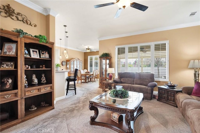 carpeted living room featuring crown molding and ceiling fan