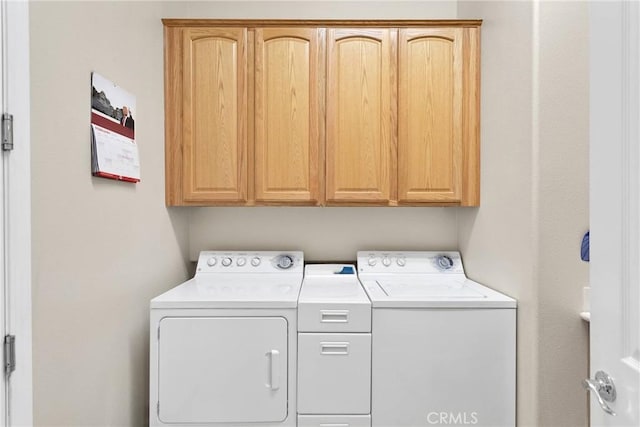 laundry area with cabinets and washing machine and clothes dryer