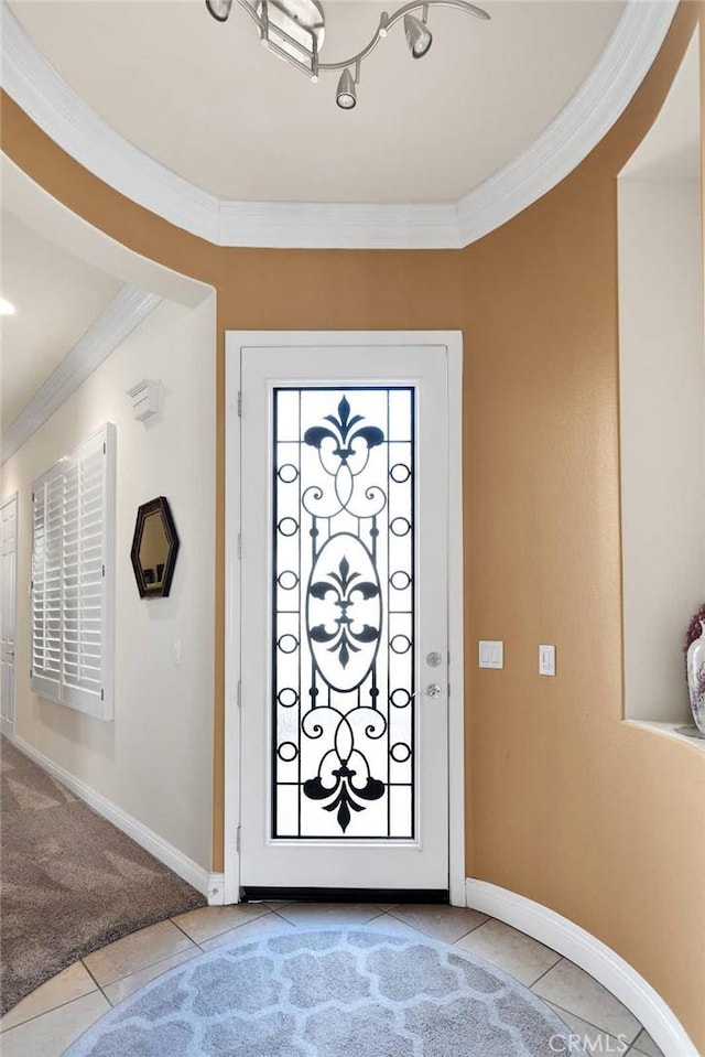 entrance foyer featuring light tile patterned flooring and ornamental molding