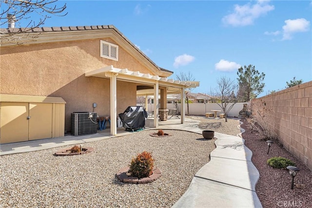 back of property with central AC unit and a patio area