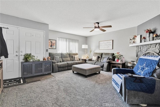 living room with ceiling fan, a textured ceiling, and carpet flooring