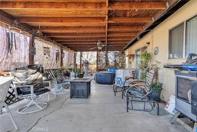 view of patio / terrace featuring ceiling fan and a fire pit