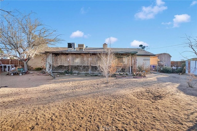 rear view of property with fence