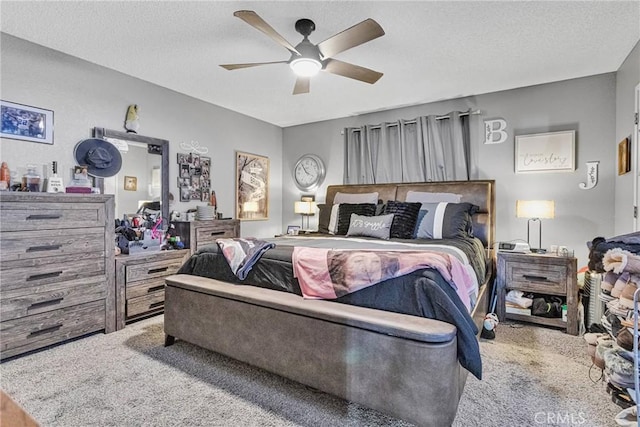 carpeted bedroom with ceiling fan and a textured ceiling