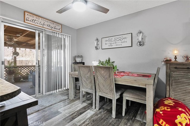 dining area with wood-type flooring and ceiling fan