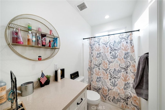 bathroom with vanity, toilet, and curtained shower