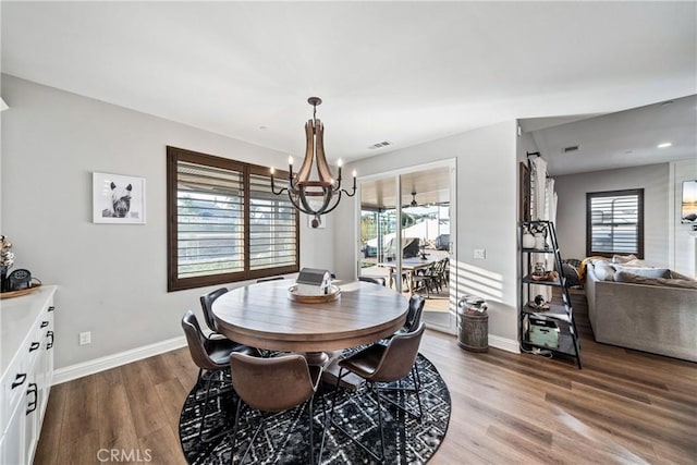 dining room featuring wood-type flooring and an inviting chandelier