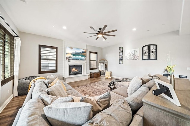 living room featuring ceiling fan and hardwood / wood-style floors