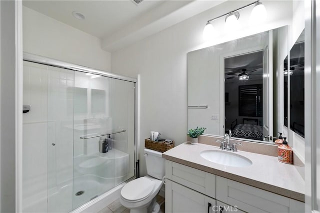 bathroom with vanity, toilet, and a shower with door