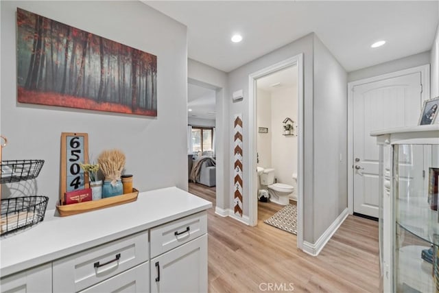 interior space with white cabinets and light wood-type flooring