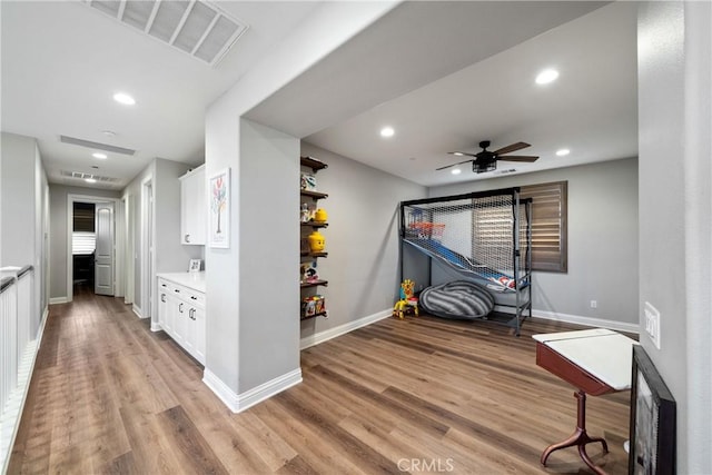 interior space with light hardwood / wood-style floors and ceiling fan