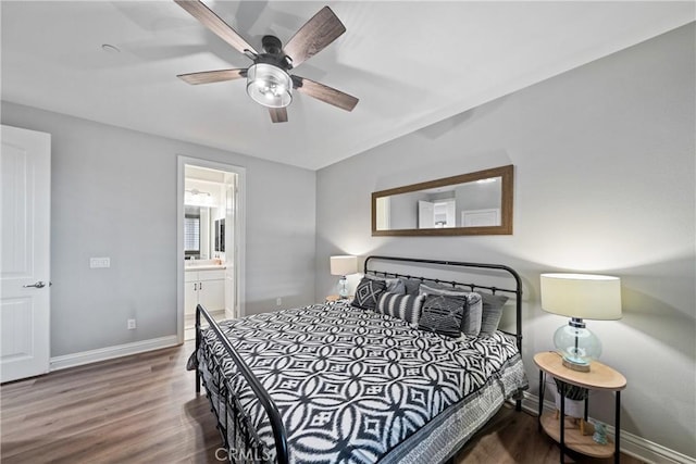 bedroom featuring ceiling fan, ensuite bath, and dark hardwood / wood-style flooring