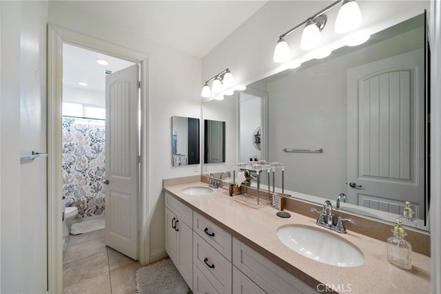 bathroom with vanity, toilet, curtained shower, and tile patterned flooring