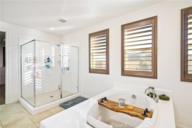 bathroom featuring shower with separate bathtub and tile patterned floors